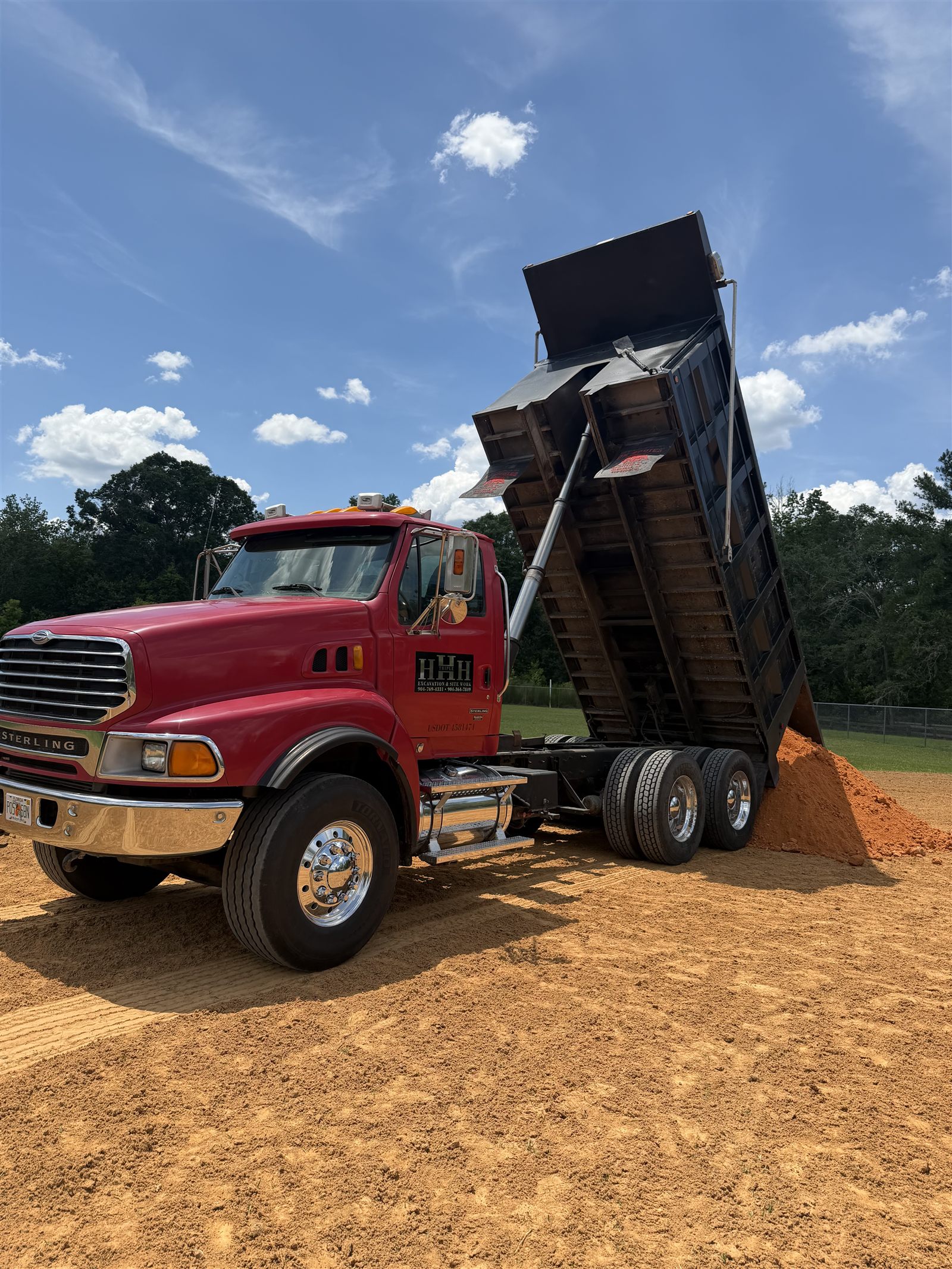 Triple H dump truck dumping a load of fill dirt