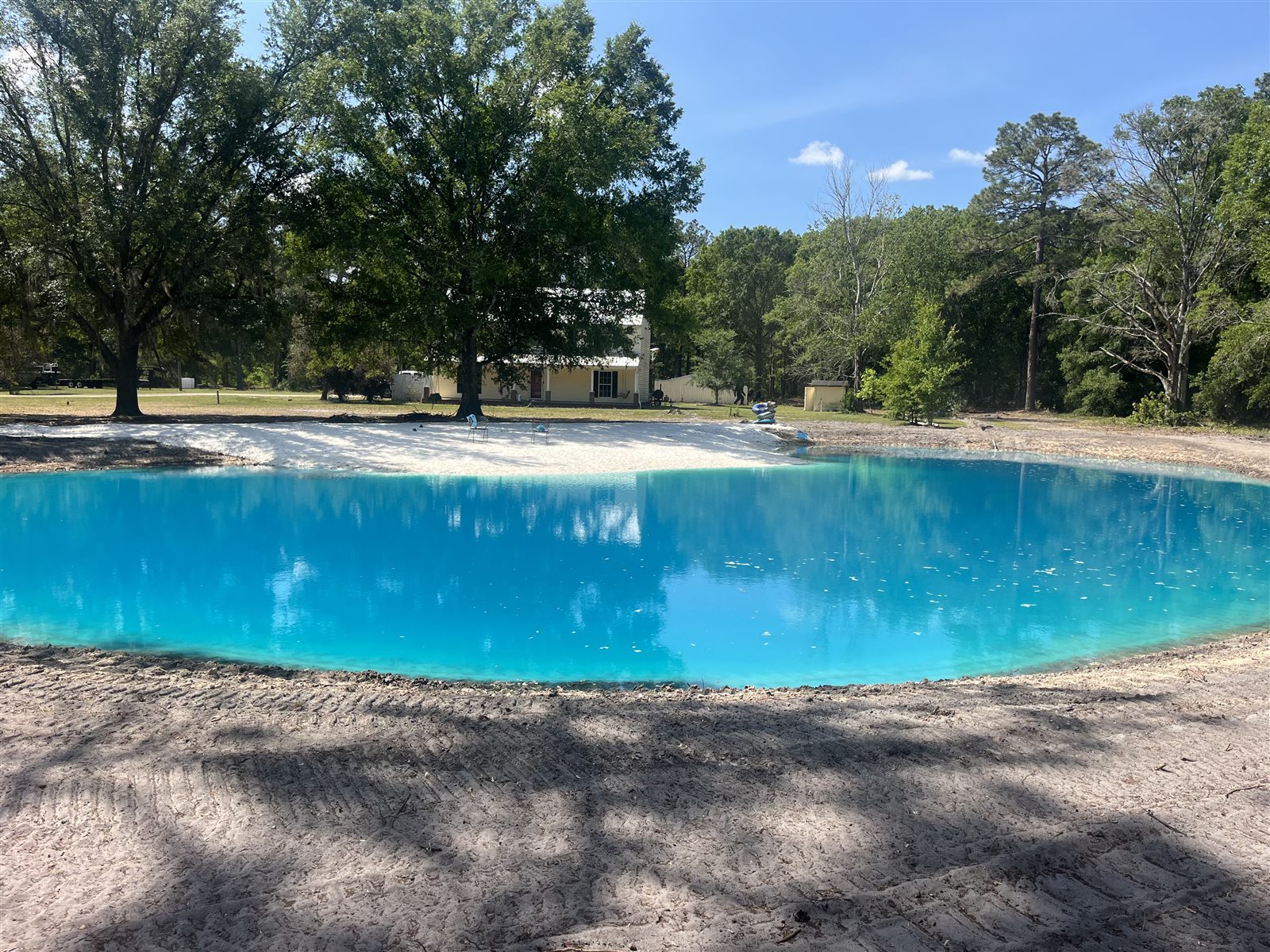 Sand delivered for a backyard pond beach